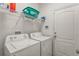 Laundry room with washer, dryer, and shelving at 2507 Torrens Dr, Lakeland, FL 33805