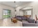 Spacious living room with tiled floors, gray couches, and access to a patio at 2507 Torrens Dr, Lakeland, FL 33805