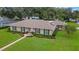 Ranch-style home with landscaped yard and solar panels at 2620 Jonila Ave, Lakeland, FL 33803