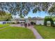 Brick patio and grassy backyard with seating area at 2620 Jonila Ave, Lakeland, FL 33803
