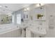 Clean bathroom with double vanity, large mirror, and soaking tub at 2620 Jonila Ave, Lakeland, FL 33803