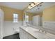 Bathroom with double vanity, granite countertop, and large mirror at 2620 Jonila Ave, Lakeland, FL 33803
