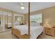 Main bedroom with a large wooden post bed and mirrored closet doors at 2620 Jonila Ave, Lakeland, FL 33803