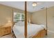 Bright bedroom with a wooden post bed and ample natural light at 2620 Jonila Ave, Lakeland, FL 33803