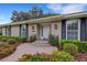 House entrance with brick walkway and lush landscaping at 2620 Jonila Ave, Lakeland, FL 33803