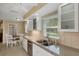Bright kitchen boasts white cabinets, granite countertops, and a breakfast nook at 2620 Jonila Ave, Lakeland, FL 33803
