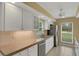 Bright kitchen with white cabinets, granite countertops, and stainless steel appliances at 2620 Jonila Ave, Lakeland, FL 33803