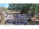 Aerial view of a cozy single-story home with a covered porch surrounded by lush greenery at 3016 Hutchins St, Eaton Park, FL 33840