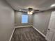 Cozy bedroom featuring soft carpet, a ceiling fan, and a bright window at 3016 Hutchins St, Eaton Park, FL 33840
