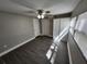 Bright bedroom features wood-look flooring, ceiling fan and closet space at 3016 Hutchins St, Eaton Park, FL 33840