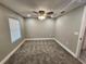 Carpeted bedroom with a ceiling fan, natural light, and fresh paint at 3016 Hutchins St, Eaton Park, FL 33840