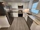 Modern kitchen featuring stainless steel appliances, granite countertops and white cabinetry at 3016 Hutchins St, Eaton Park, FL 33840