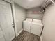 Convenient laundry room featuring a washer, dryer, and shelving for storage at 3016 Hutchins St, Eaton Park, FL 33840