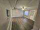 Spacious living room featuring wood-look flooring and a modern ceiling fan at 3016 Hutchins St, Eaton Park, FL 33840