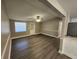 Open living room with wood floors, ceiling fan, and a neutral color palette at 3016 Hutchins St, Eaton Park, FL 33840