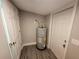 Utility room featuring a water heater, storage space, and a doorway for easy access at 3016 Hutchins St, Eaton Park, FL 33840