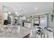 Bright kitchen with island, white cabinets, and view to backyard at 3173 Sand Trap Ct, Lakeland, FL 33810