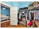 Well-organized closet with hanging clothes and storage bins at 360 N Lake Shore Way, Lake Alfred, FL 33850