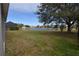 Spacious backyard with pond view and lush green grass at 3648 Julius Estates Blvd, Winter Haven, FL 33881