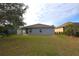 Gray house exterior with a backyard at 3648 Julius Estates Blvd, Winter Haven, FL 33881