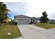 Gray house exterior with attached garage and driveway at 3648 Julius Estates Blvd, Winter Haven, FL 33881