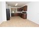 Kitchen with dark wood cabinets and black appliances at 3648 Julius Estates Blvd, Winter Haven, FL 33881