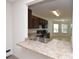 Kitchen features dark wood cabinets, a breakfast bar and a view to the dining room at 3648 Julius Estates Blvd, Winter Haven, FL 33881