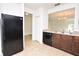 Black appliances and dark wood cabinets in this open kitchen at 3648 Julius Estates Blvd, Winter Haven, FL 33881