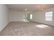 Large living room with neutral carpeting and lots of natural light at 3648 Julius Estates Blvd, Winter Haven, FL 33881
