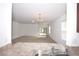 Spacious living room with carpeting, sliding glass doors, and chandelier at 3648 Julius Estates Blvd, Winter Haven, FL 33881