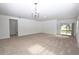 Open living area with carpeting and access to the backyard at 3648 Julius Estates Blvd, Winter Haven, FL 33881