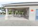 Covered patio area with table and chairs near the pool at 3648 Julius Estates Blvd, Winter Haven, FL 33881