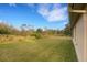 Spacious backyard with grassy lawn and mature trees at 4111 Cobblestone Dr, Lakeland, FL 33813