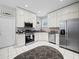 Modern kitchen with white cabinets, stainless steel appliances, and granite countertops at 4463 Pebble Pointe Dr, Lakeland, FL 33813