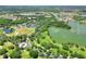 Aerial view of community with lake, golf course, and homes at 453 Treviso Dr, Kissimmee, FL 34759