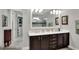 Elegant bathroom with double vanity, large mirror, and walk-in shower at 453 Treviso Dr, Kissimmee, FL 34759
