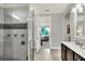 Bathroom boasts a large shower, double vanity, and modern fixtures at 453 Treviso Dr, Kissimmee, FL 34759