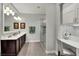 Elegant bathroom with a double vanity, walk-in shower, and a makeup vanity at 453 Treviso Dr, Kissimmee, FL 34759