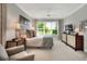 Relaxing bedroom with plush bed, ample natural light, and stylish dresser at 453 Treviso Dr, Kissimmee, FL 34759