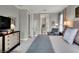Main bedroom with a dresser, seating area, and en-suite bathroom access at 453 Treviso Dr, Kissimmee, FL 34759