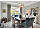 Elegant dining room with a large table and modern light fixture at 453 Treviso Dr, Kissimmee, FL 34759
