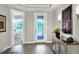 Bright and spacious foyer with wood-look tile flooring and elegant decor at 453 Treviso Dr, Kissimmee, FL 34759