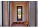 Front door entry with a decorative doormat and a small bench at 453 Treviso Dr, Kissimmee, FL 34759