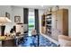 Bright home office features built-in shelving, large window, and stylish furnishings at 453 Treviso Dr, Kissimmee, FL 34759
