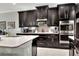 Modern kitchen with dark cabinetry and stainless steel appliances at 453 Treviso Dr, Kissimmee, FL 34759