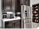 Modern kitchen features stainless steel refrigerator and dark wood cabinetry at 453 Treviso Dr, Kissimmee, FL 34759