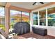 This screened patio features a grill and comfortable seating at 453 Treviso Dr, Kissimmee, FL 34759