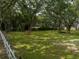 Open pasture with large oak trees and a white fence at 4850 Old Berkley Rd, Auburndale, FL 33823