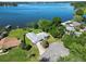 Aerial view of a single-story home on the lake, with a large backyard and boat access at 5252 Post Ln, Lakeland, FL 33809