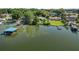 Aerial view showcasing lakefront home and dock at 5252 Post Ln, Lakeland, FL 33809